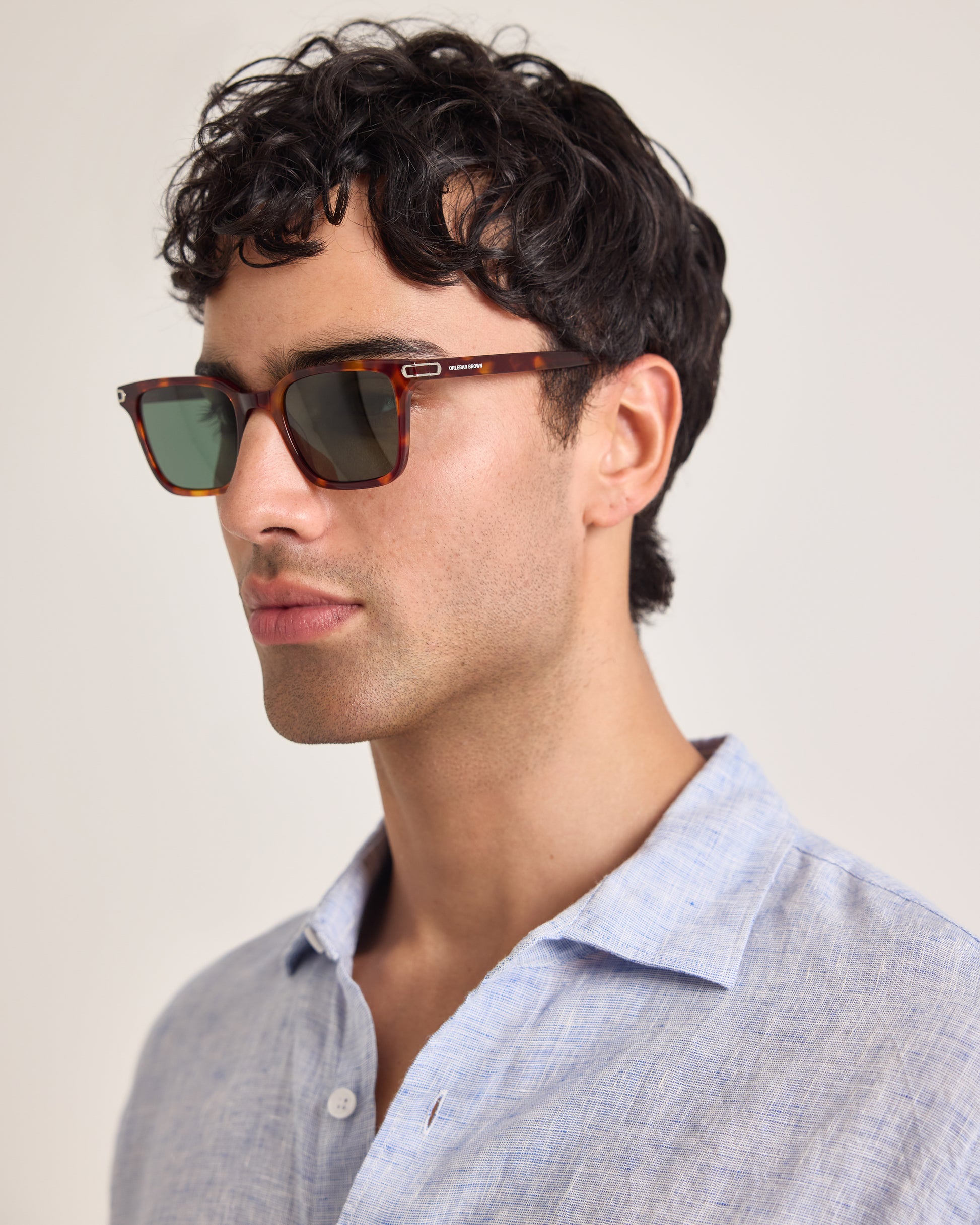 Man wearing sunglasses with a neutral background