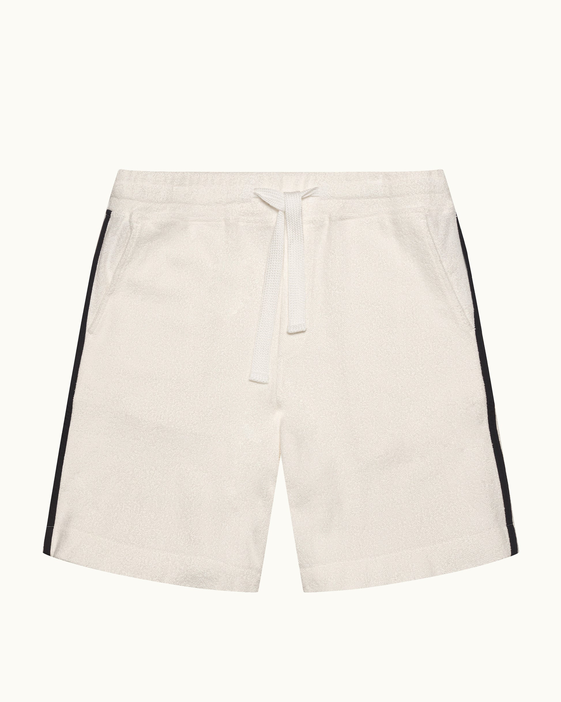Beige shorts with black side stripes on a white background