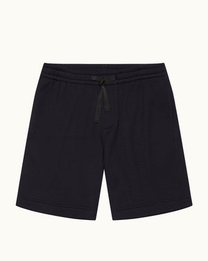 Navy towelling sweat shorts with drawstring waist on a plain background