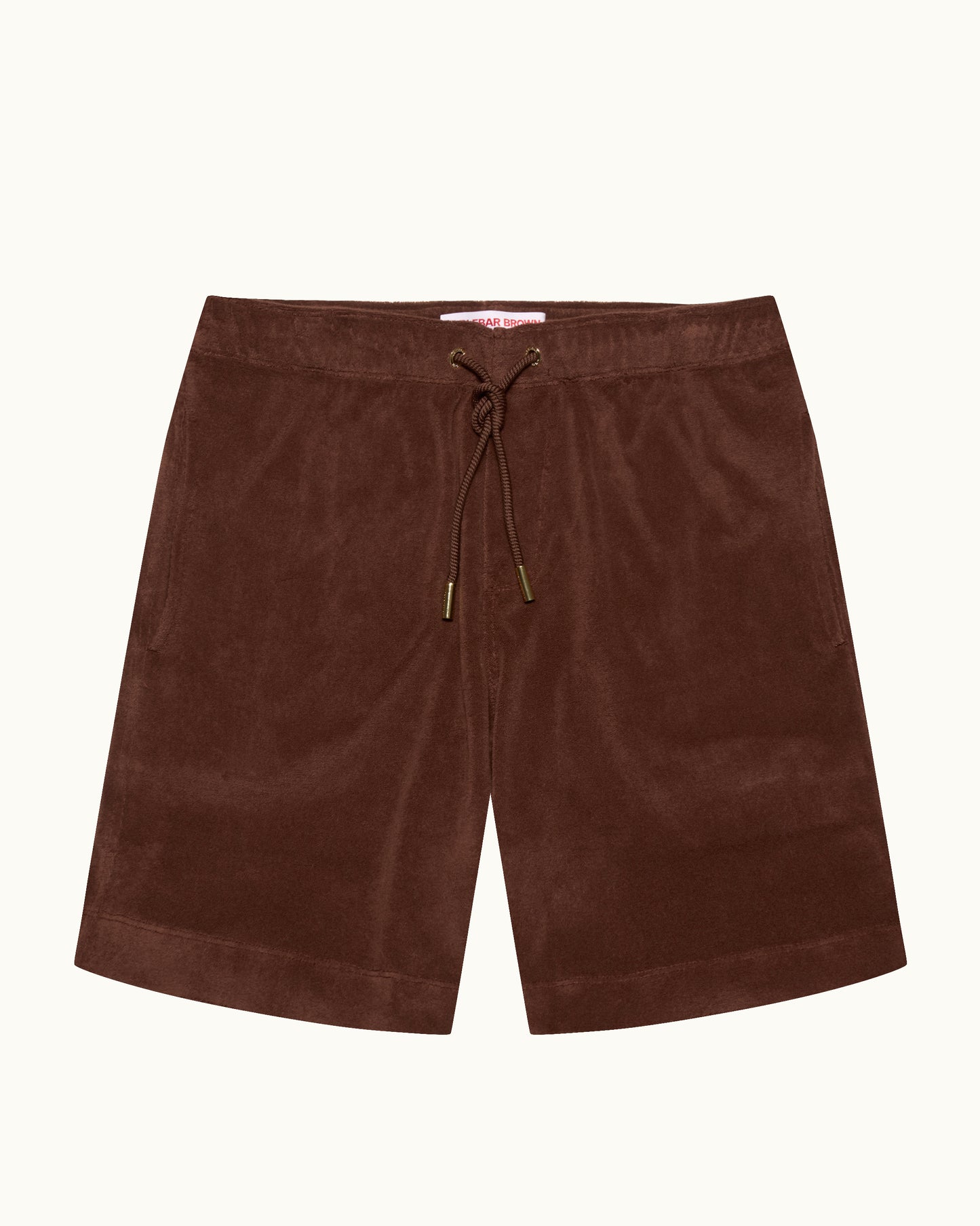 A pair of dark brown shorts with an elastic drawstring waistband, laid flat against a light cream background.