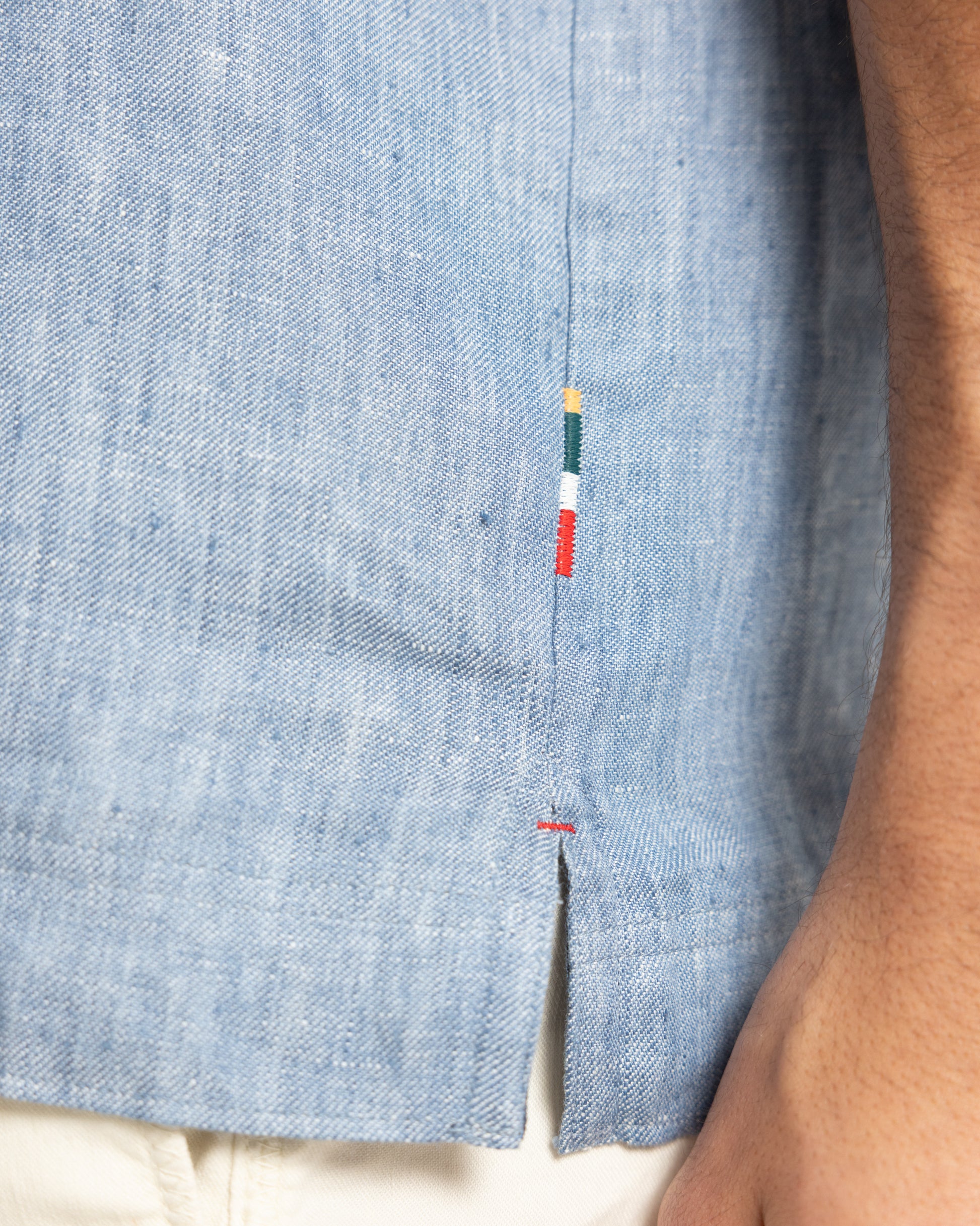 Closeup of blue shirt with branded embroidery 