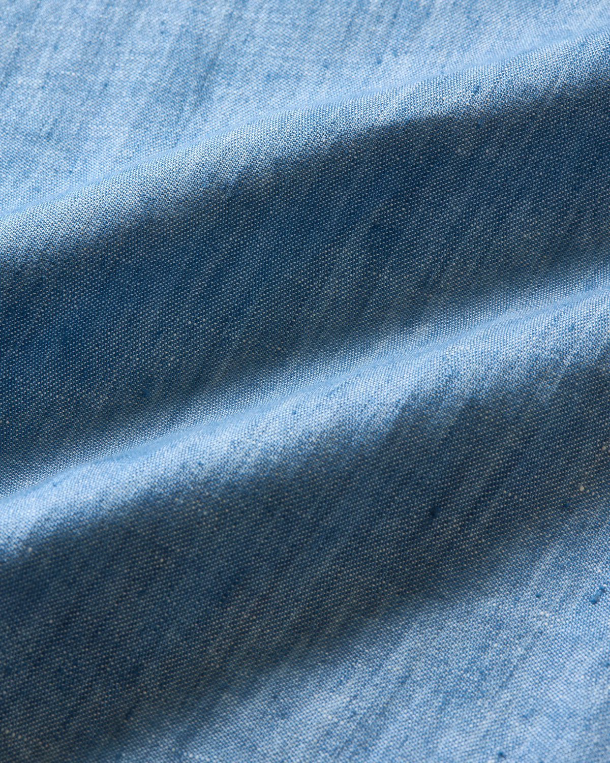 Close-up of blue fabric with texture and color variations