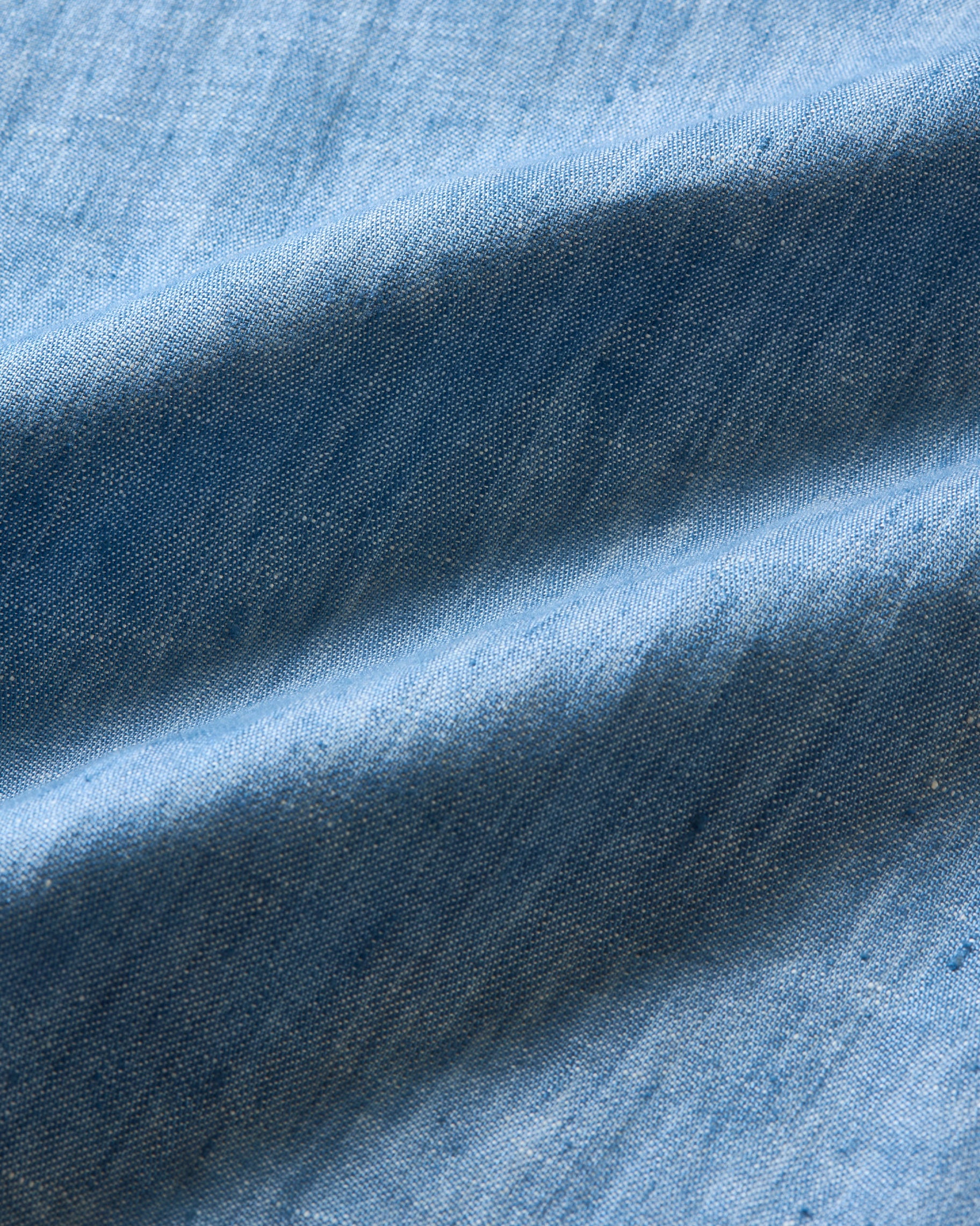 Close-up of blue fabric with texture and color variations
