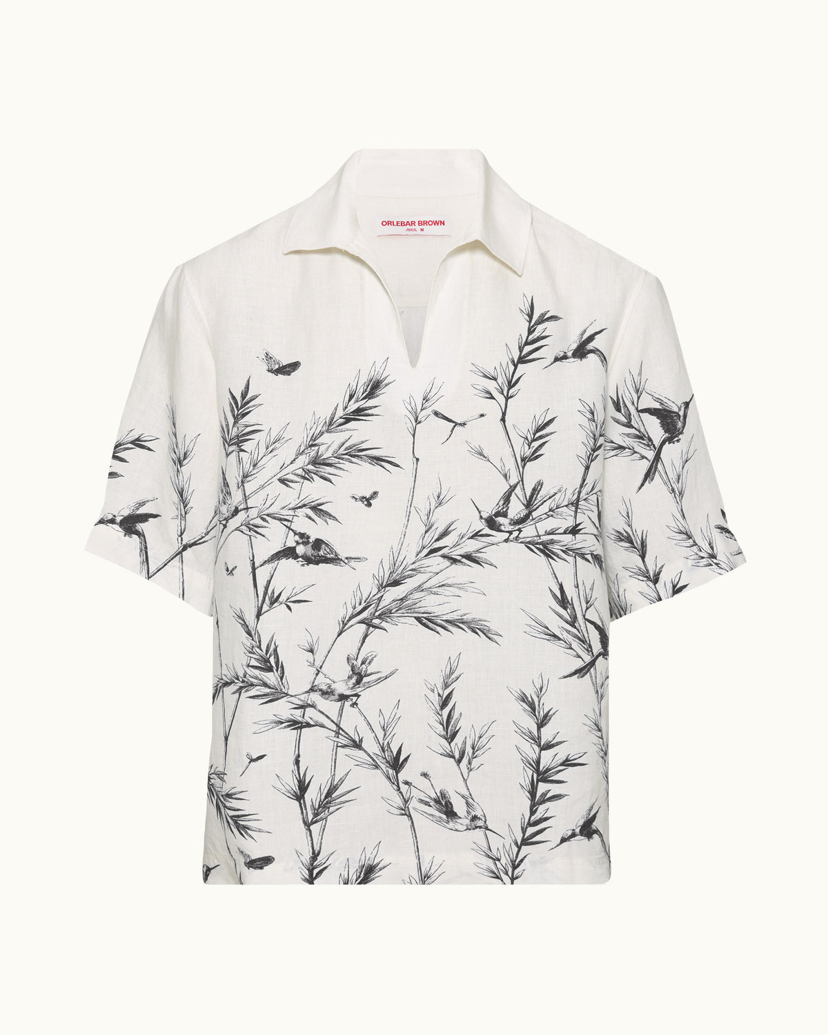 White short-sleeved linen shirt with black pattern on a plain background