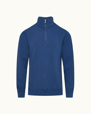 Dark blue quarter zip sweatshirt on a plain background