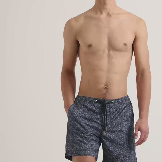 Man wearing printed swin shorts with drawcord