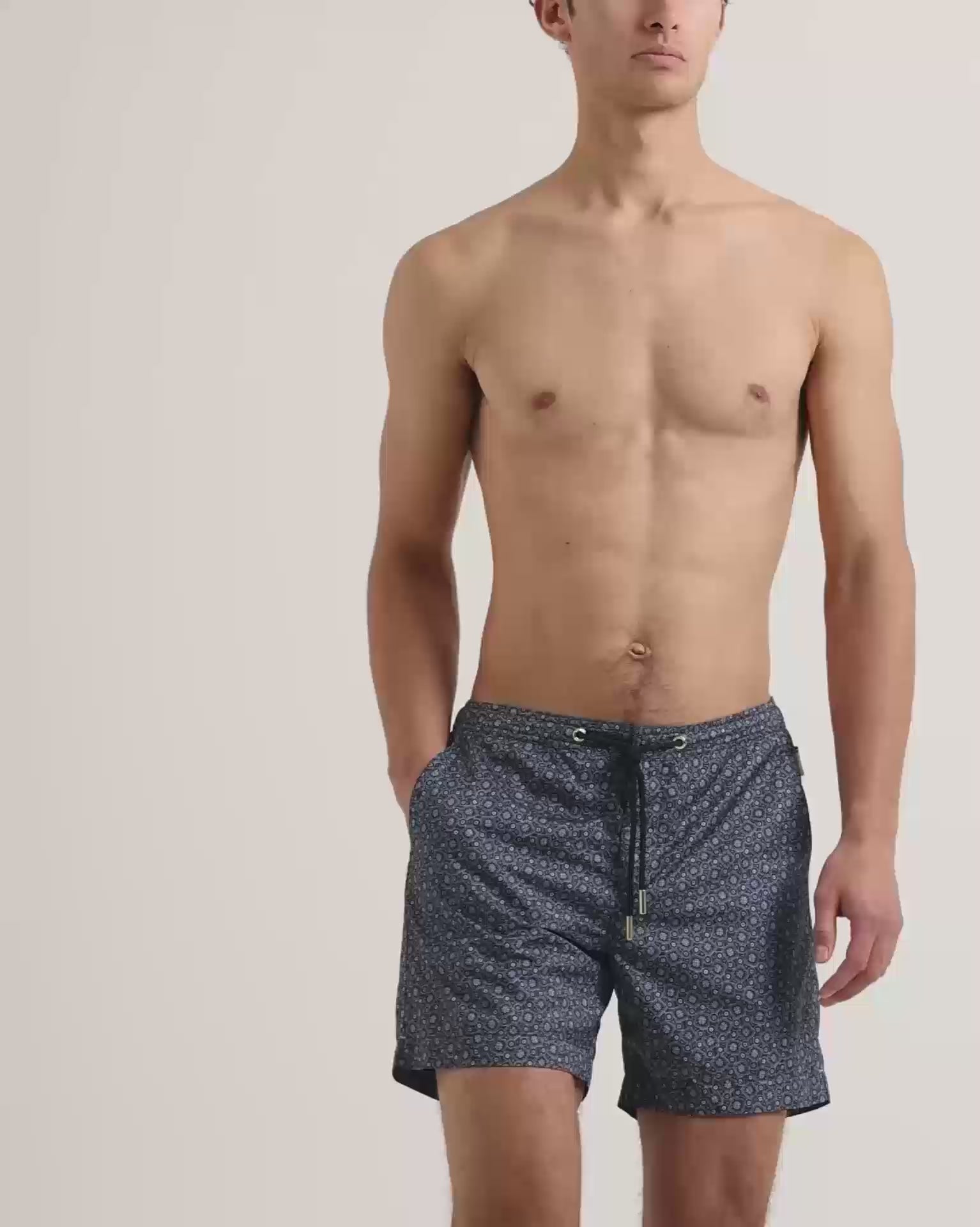 Man wearing printed swin shorts with drawcord