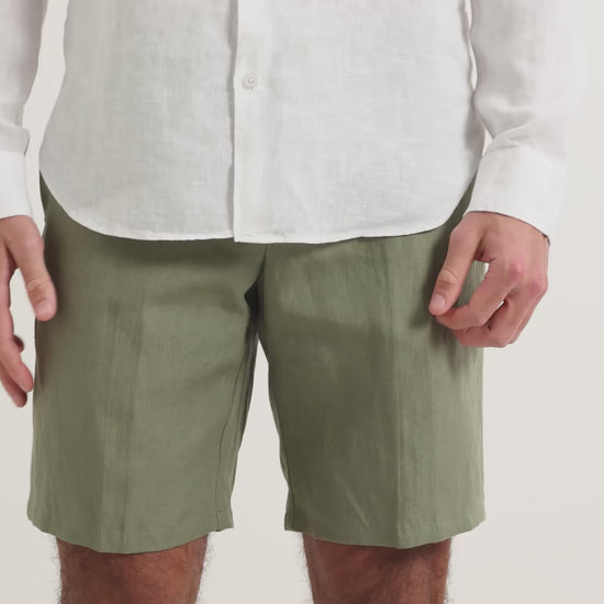 Man wearing white linen shirt with green linen shorts