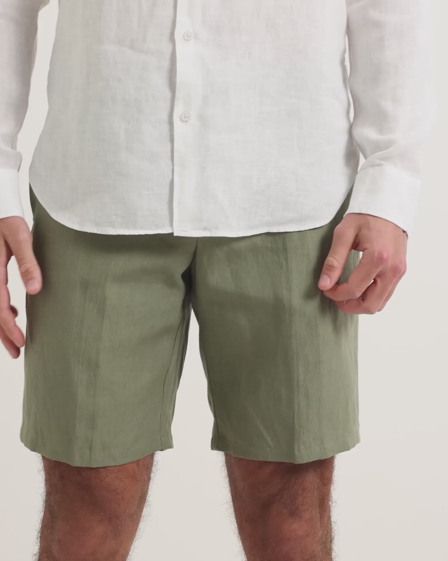 Man wearing white linen shirt with green linen shorts