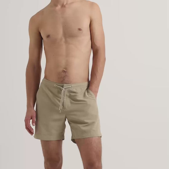 Man wearing light beige drawstring swim shorts