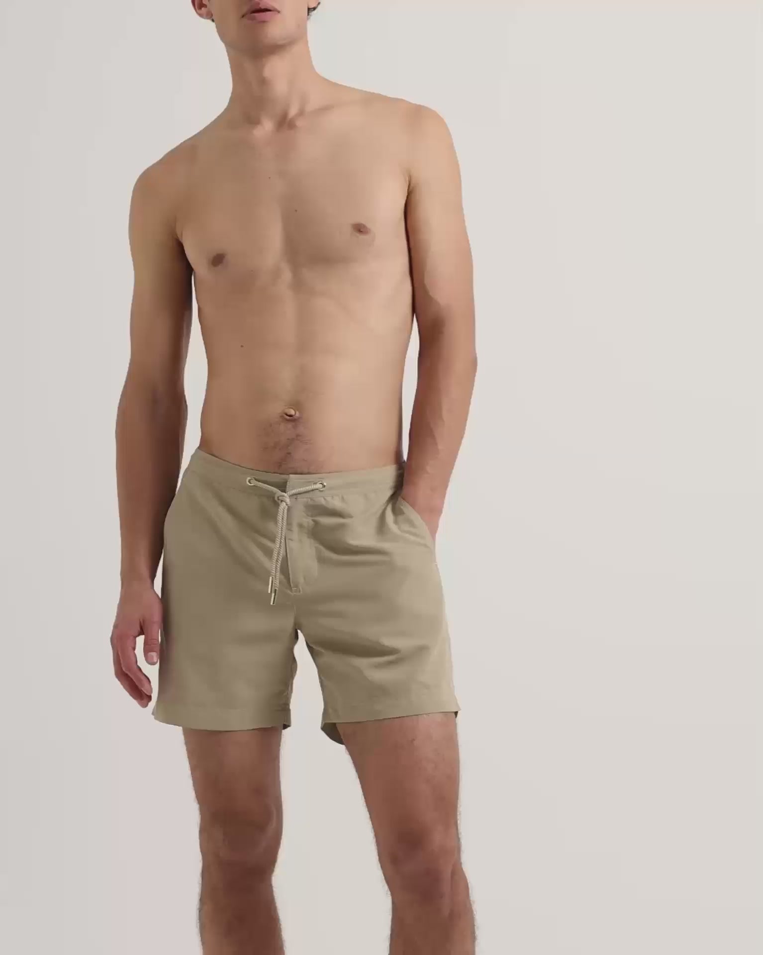 Man wearing light beige drawstring swim shorts