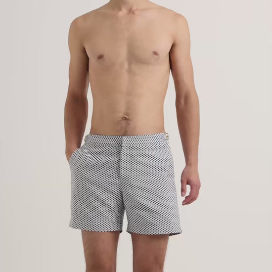 Man wearing patterned swim shorts in navy and white