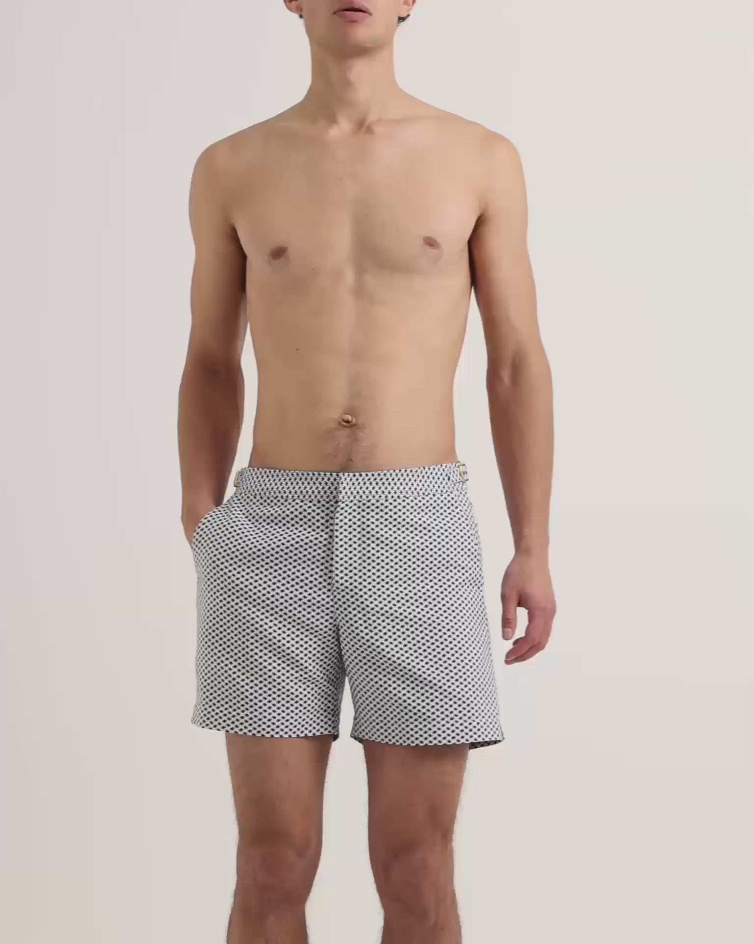 Man wearing patterned swim shorts in navy and white