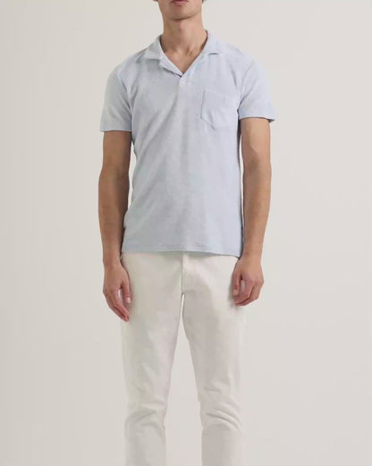 Light blue terry towelling polo shirt with white trousers